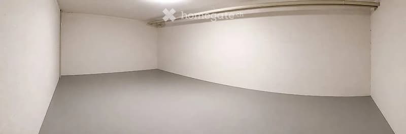 Empty room with white walls and grey floor, no furniture or equipment.