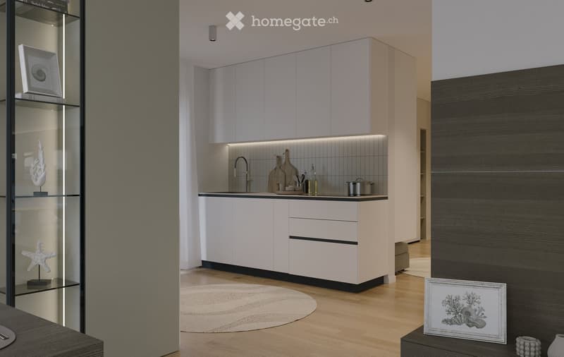 Modern kitchen with white cabinets, a central island, and a sleek sink area. The space features a wooden floor, a round rug, and decorative items including framed pictures and a shelf with a starfish.