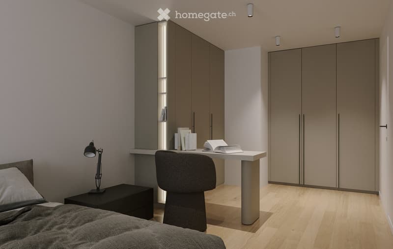 Modern bedroom with a bed, nightstand, desk, chair, and books. The room features sleek, grey-toned furniture and warm lighting.