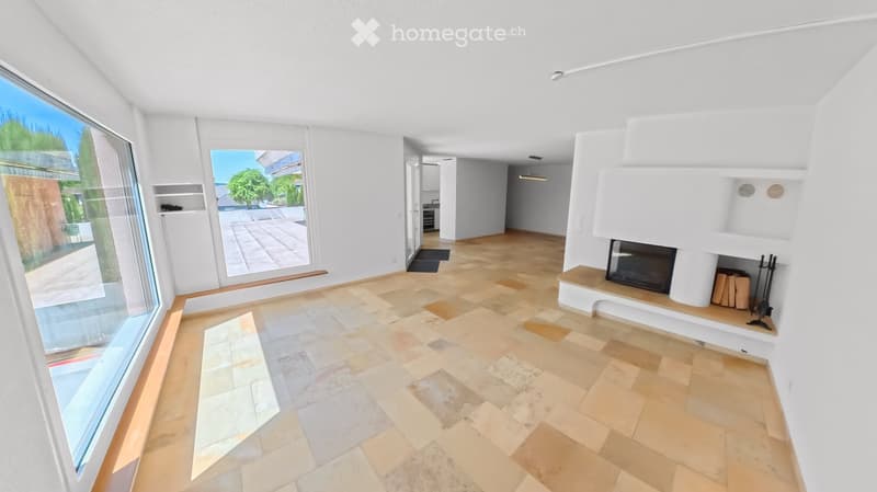 Modern living room with large windows, fireplace, and tiled floor.