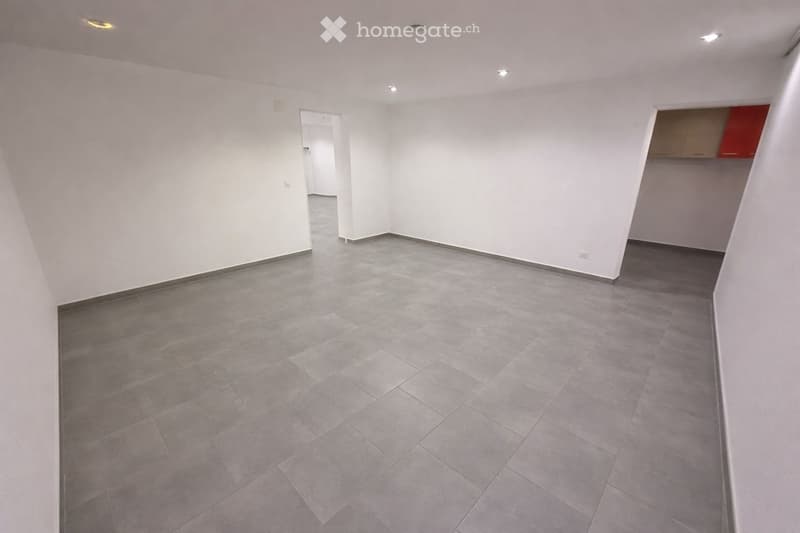 Empty room with white walls and tiled flooring