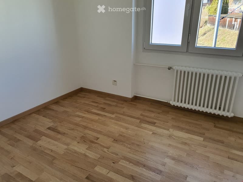 empty room, white walls, wooden floor, white radiator, windows