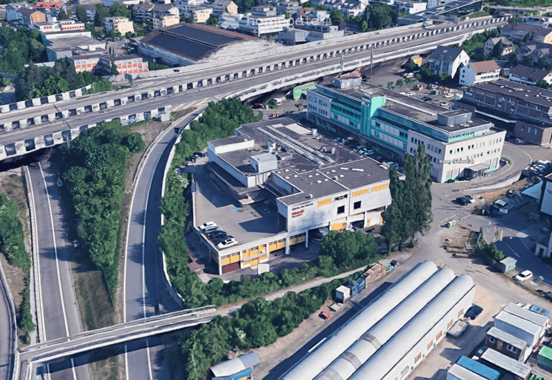 large building complex, several buildings, several roads, one with a bridge