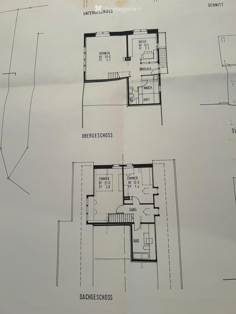 Floor plan showing three levels: basement with living room, kitchen, and bathroom; upper level with two bedrooms and hallway; attic level with additional space.