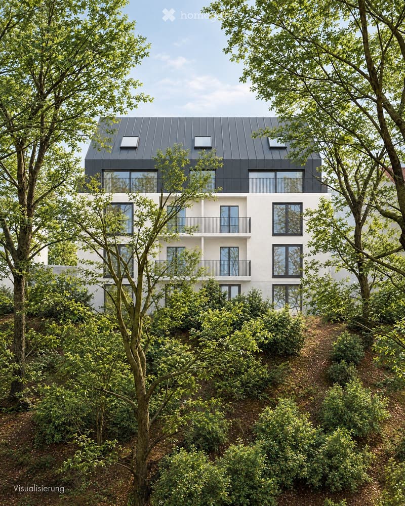Modern two-story house with white walls, dark grey roof, multiple large windows, and balconies surrounded by lush greenery.