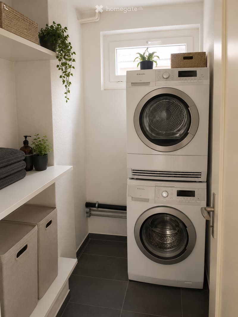 Modern bathroom with a stacked washer and dryer, shelves with towels and plants, and a window with a view of greenery.
