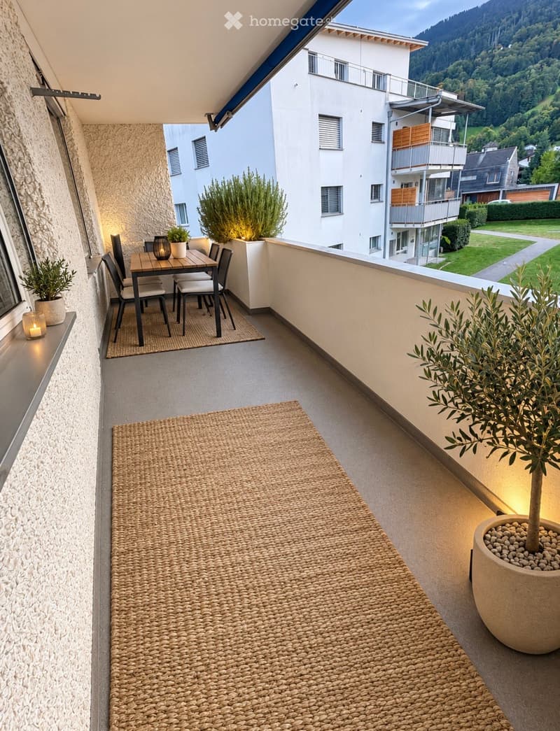 Balcony with a small dining area, potted plants, and scenic mountain view.