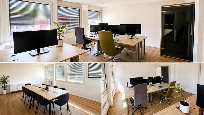 Modern office space with multiple workstations, large wooden tables, ergonomic chairs, multiple computer screens, and potted plants.