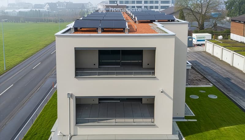 Modern house with solar panels on the roof, multiple terraces, raised ground floor