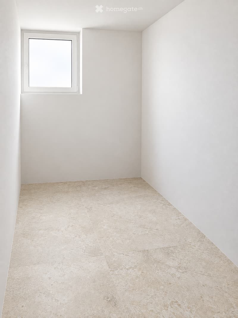 Empty room with white walls, beige tiled floor, and a single window with white frame.