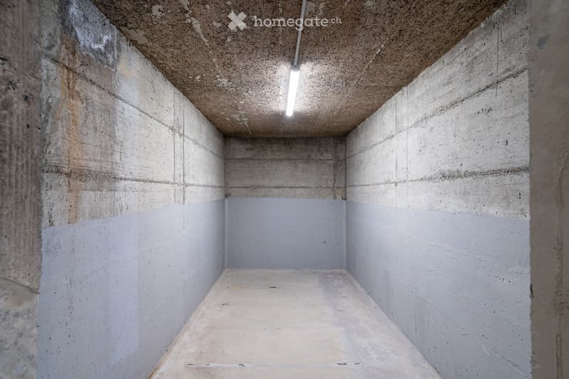 Empty concrete room with bare walls, ceiling, and floor. No furniture or equipment visible.