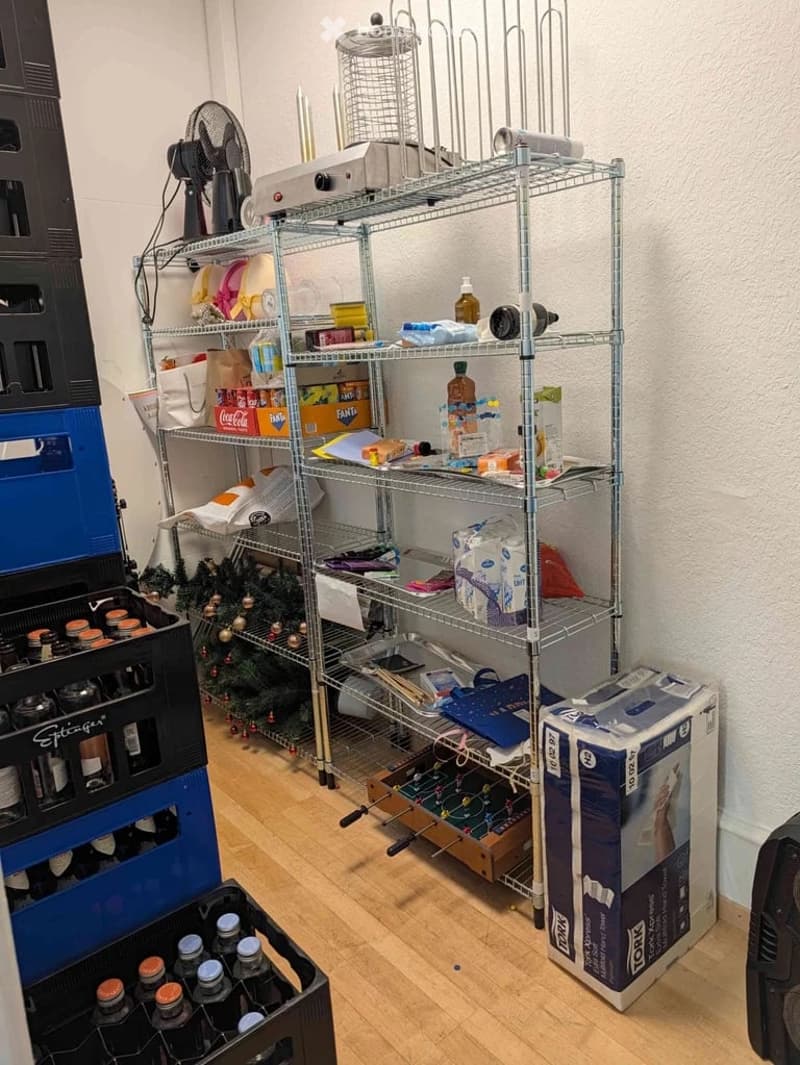 {"visible_features": [], "type": "Furnished Room", "objects": ["shelf", "fan", "cage", "bottle", "bottle", "bottle", "bottle", "bottle", "bottle", "bottle", "bottle", "bottle", "bottle", "bottle", "bottle", "bottle", "bottle", "bottle", "bottle", "bottle"