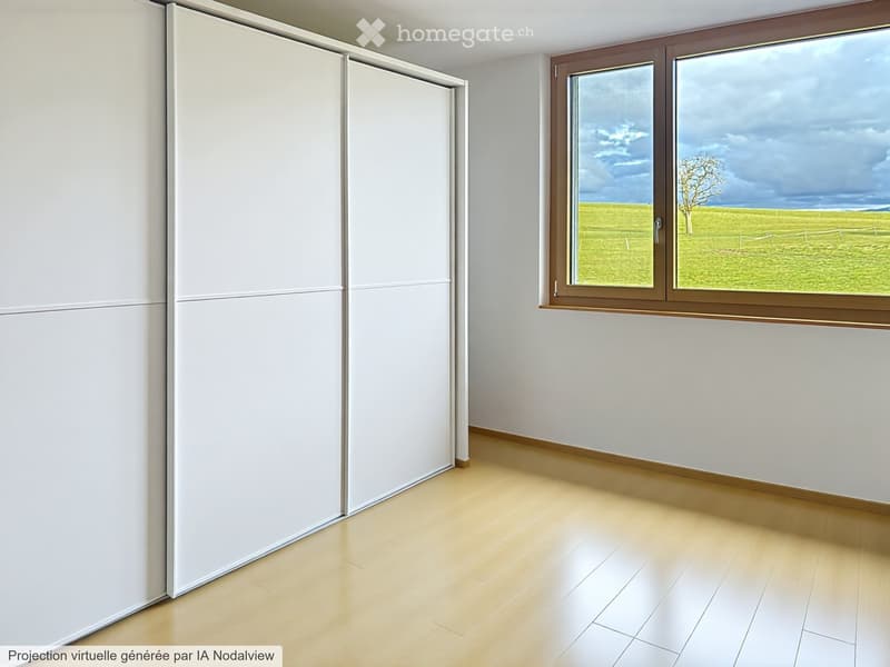Empty room with light wooden flooring, white walls, large window with brown frame, and white sliding doors.