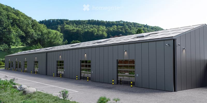 Modern industrial-style building with large garage doors, solar panels on the roof, and a paved parking area.
