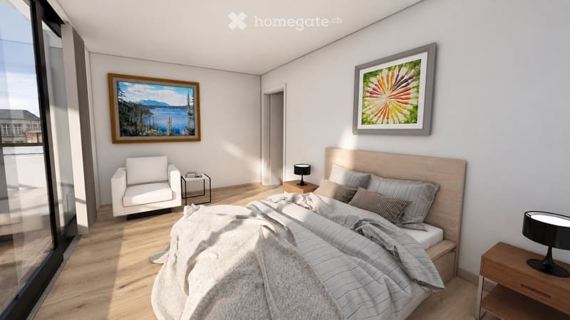 Modern bedroom with a large bed, nightstands, a white armchair, and two framed pictures on the wall. The room features wooden flooring and large windows with a view.