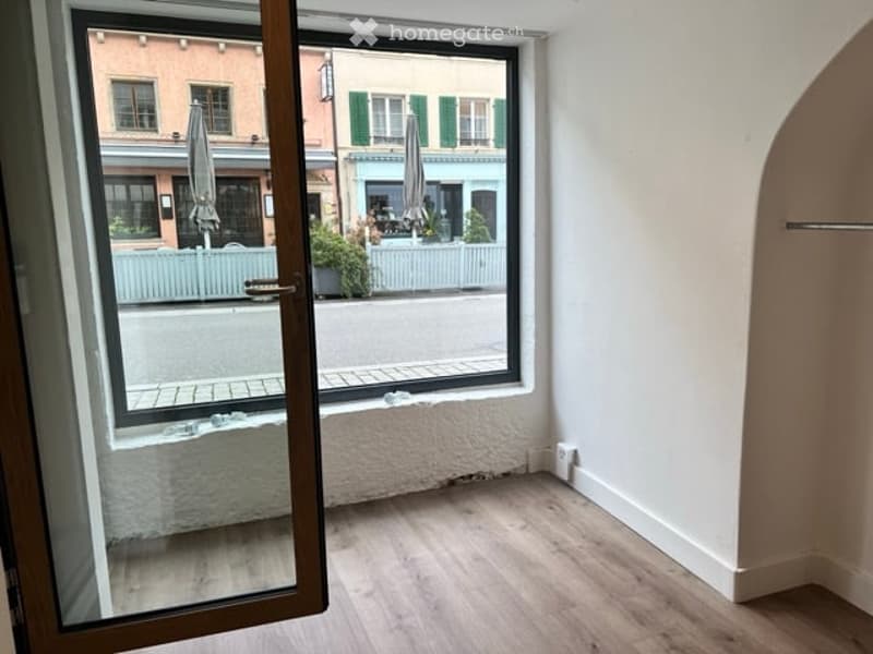 large window, glass door, wooden floor, clear view of the outside