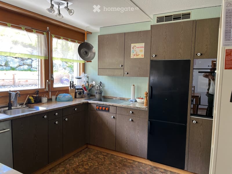 {"type": "Kitchen", "objects": ["sink", "faucet", "refrigerator", "oven", "cabinets", "blender", "frying pan", "cutting board", "bowl", "cup", "knife block", "spoon rack", "oven knobs", "faucet", "faucet handle", "faucet sprayer", "faucet sprayer handle",