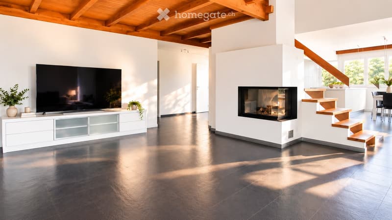 Modern living room with a sleek black television on a white cabinet, a built-in fireplace, and a staircase leading to another level. The space features a polished dark floor and white walls with wooden beams on the ceiling.