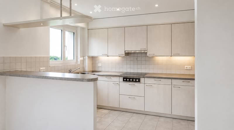 Modern kitchen with white cabinets, granite countertop, stainless steel sink and stove, and built-in lighting.