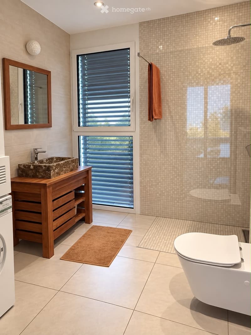 Modern bathroom with a wooden vanity, stone sink, large mirror, tiled shower area, and a toilet. Features a large window with blinds and a towel hanging on the wall.