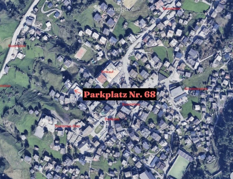 Aerial view of a town with labeled parking spot number 68, surrounded by buildings and green spaces.