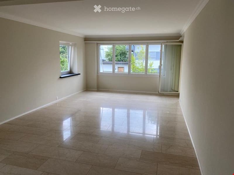 Empty room with light-colored walls, large windows, and a polished tile floor. No furniture or equipment is present.