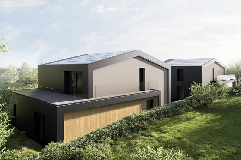 Modern two-story house with a flat roof, solar panels, large windows, and a glass balcony on the upper level. The house is surrounded by a well-maintained lawn and shrubs.