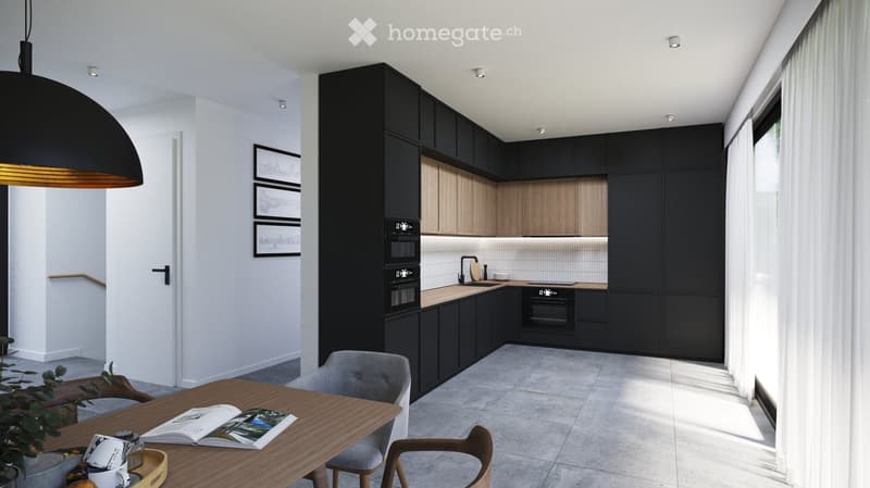 Modern kitchen with black and wood cabinets, stainless steel appliances, a wooden dining table with chairs, and a pendant light fixture.