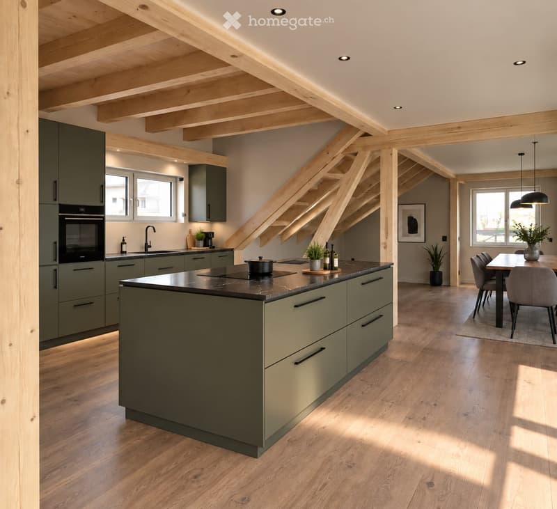Modern kitchen with green cabinets, central island, built-in oven, and dining area with table and chairs.