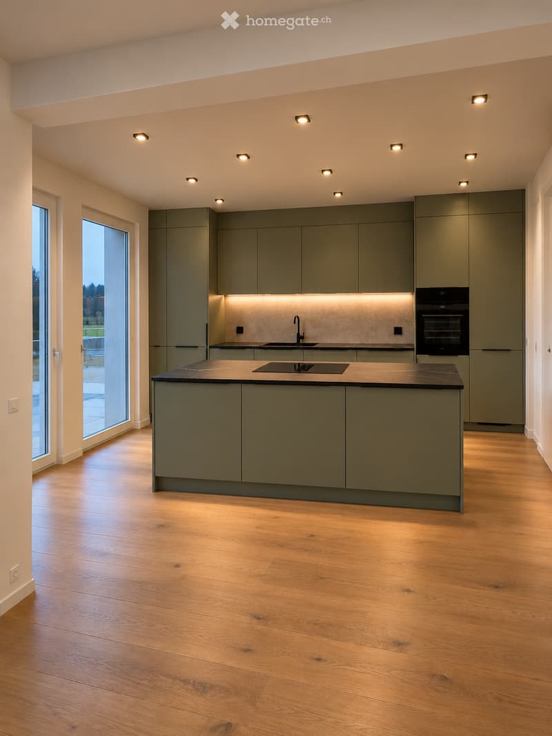 Modern kitchen with grey cabinets, wooden flooring, island, sink, and built-in oven.