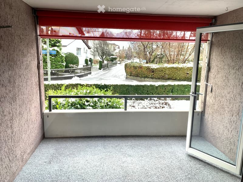 empty balcony with floor, wall, railing, door, and window with a view of a snowy landscape