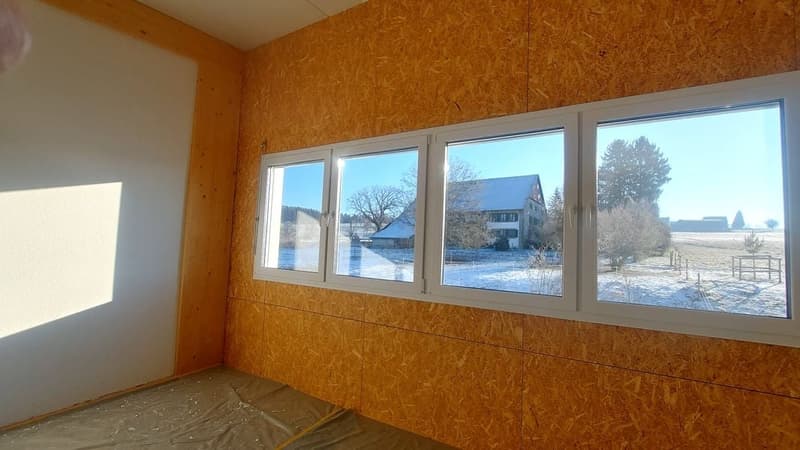 empty room, large window, wooden wall, view of snowy field