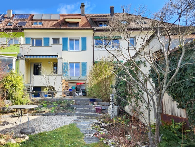 3 story house, solar panels, blue shutters, balcony, garden, stairs