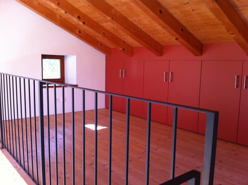wooden ceiling, wooden floor, red cabinets, window, balcony railing