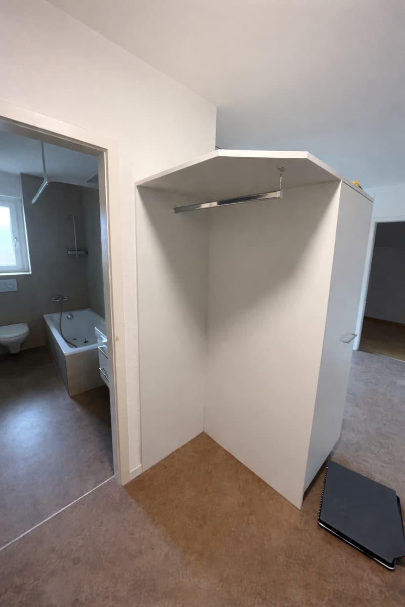 Bathroom with bathtub, toilet, and shower, corner wardrobe, wooden floor