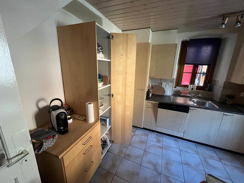 kitchen with wooden cabinets, tiled floor, sink, dishwasher, washing machine, open cabinet
