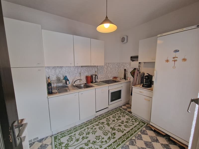 modern kitchen, white cabinets, marble countertop, stainless steel sink, gas stove, oven, refrigerator, dishwasher, washing machine, checkered floor