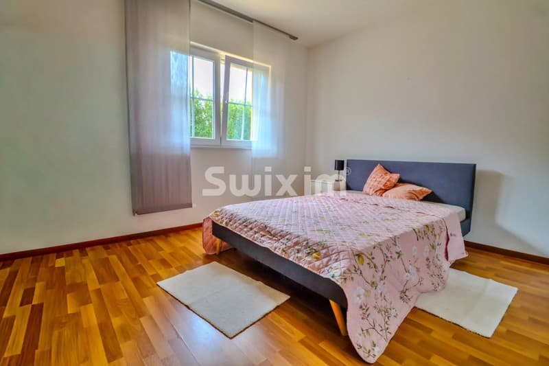 Chambre lumineuse avec un lit confortable et une décoration moderne.