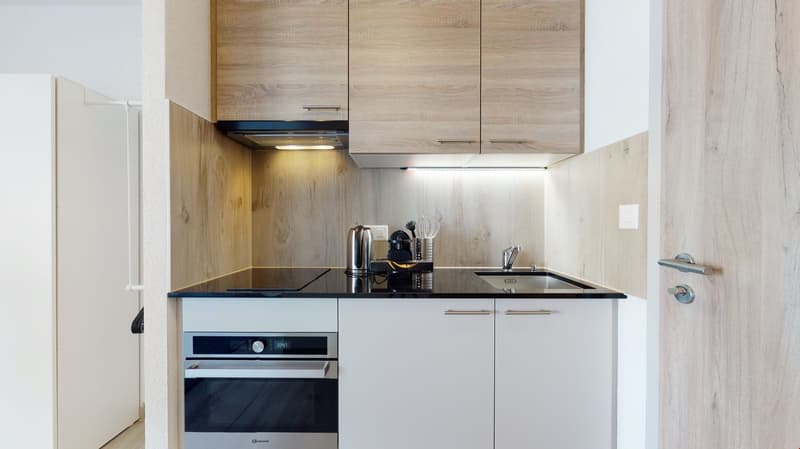 modern kitchen, wooden cabinets, black countertops, oven, sink, dishwasher, faucet, stovetop