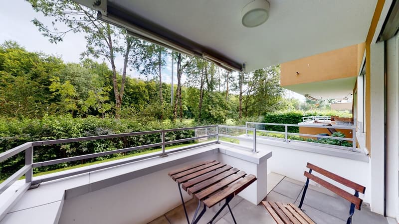 wooden table and bench on the balcony, metal railing, greenery view
