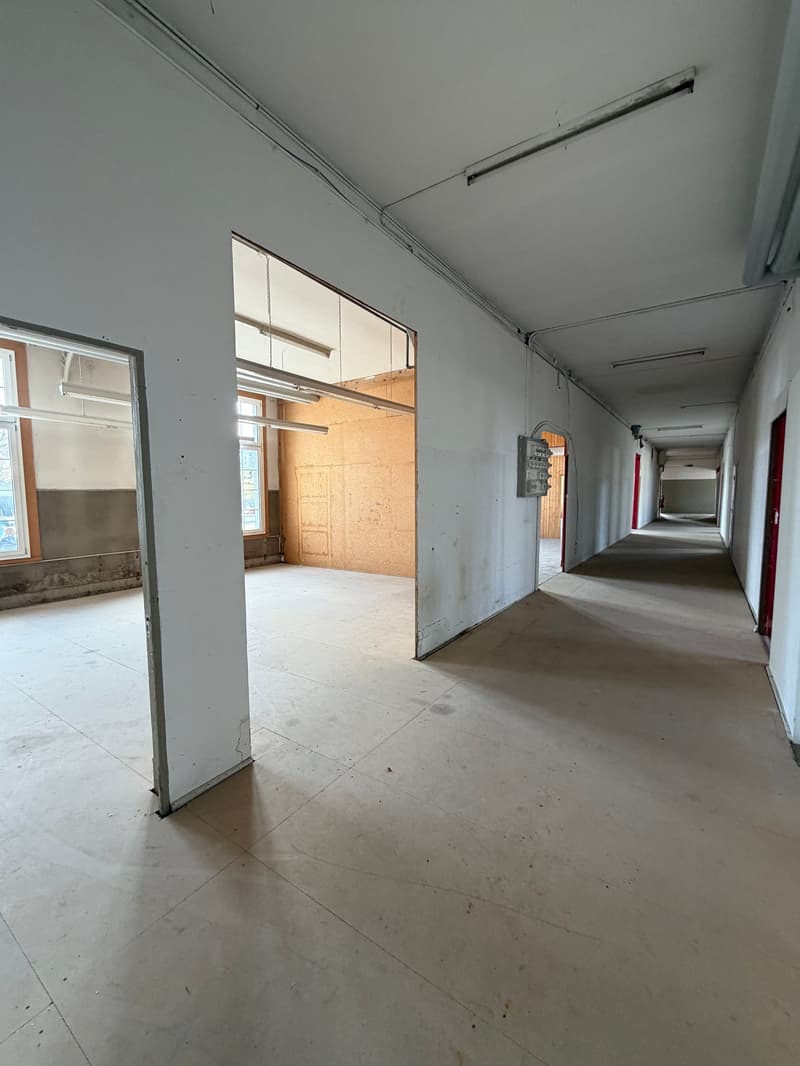 Empty hallway, white walls, tiled floor, open doors, windows, unfinished room