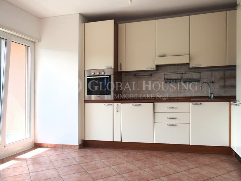 white cabinets, silver oven, white counter, white backsplash, faucet, dishwasher, dishwasher basket, oven, countertop