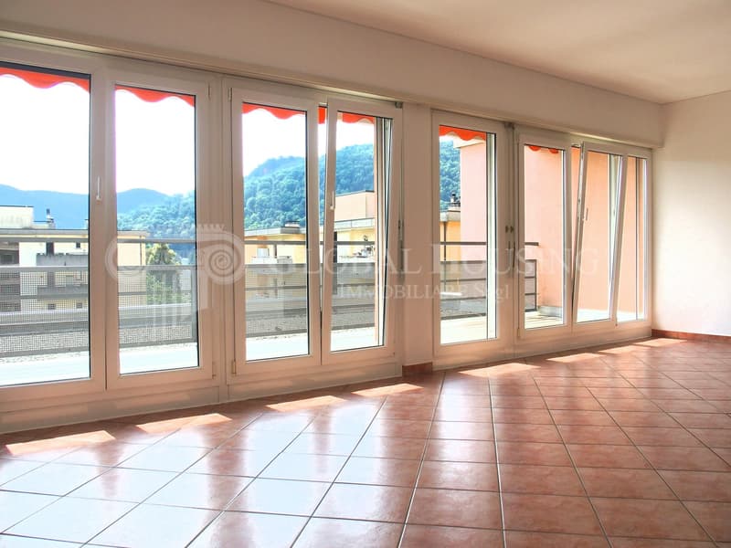 sliding glass doors with balcony access, tiled floor, no furniture