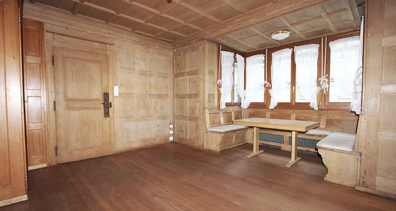 wooden walls, wooden floor, wooden table, wooden benches, windows with white curtains