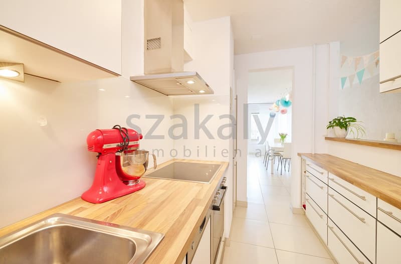 modern kitchen with wooden countertops, stainless steel sink, red mixer, white cabinets, white tiles, gas stove, oven, extractor hood, dishwasher, washing machine