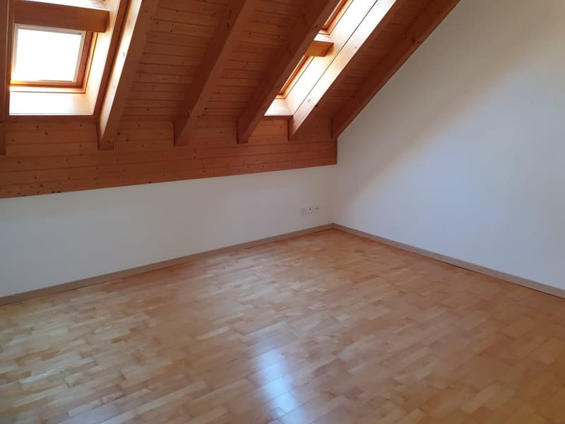 empty room with wooden ceiling and wooden floor, skylight windows