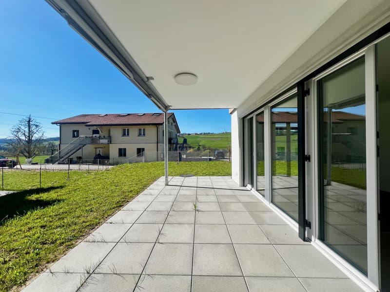 modern house, large balcony, glass doors, tiled floor, green lawn, distant building