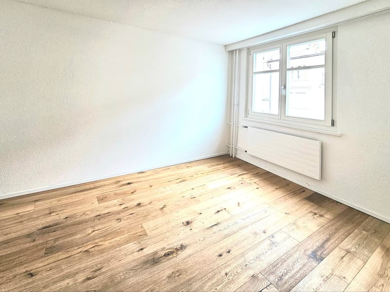 empty room, white walls, wooden floor, white window, white radiator