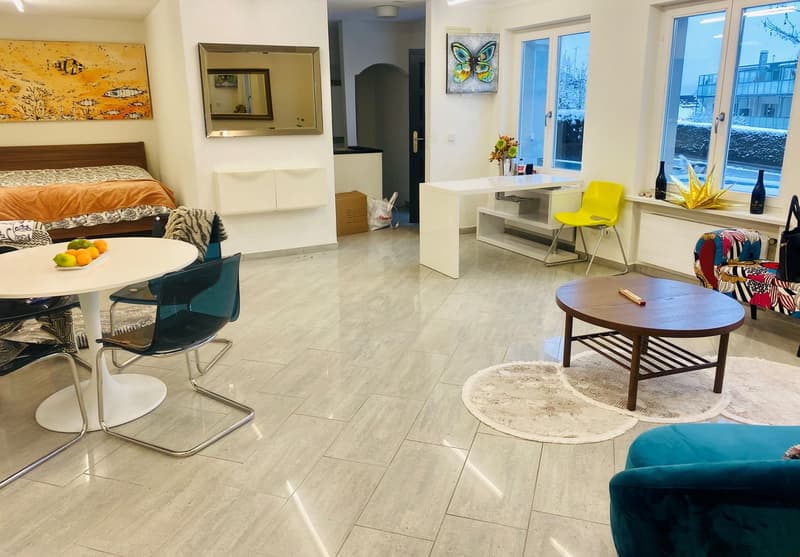 living room with couch, tables, chairs, open door to balcony