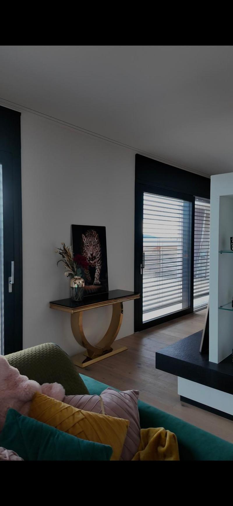modern decor, white walls, glass doors, gold table, flowers, leather sofa, balcony with view